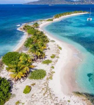 caribbean penisula surrounded by blue water - Cadillac Travel