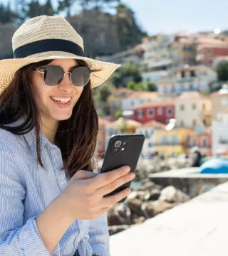 women checking her phone - Cadillac Travel
