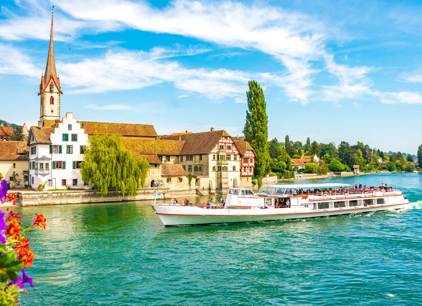 European river cruise with historic town next to river - Cadillac Travel