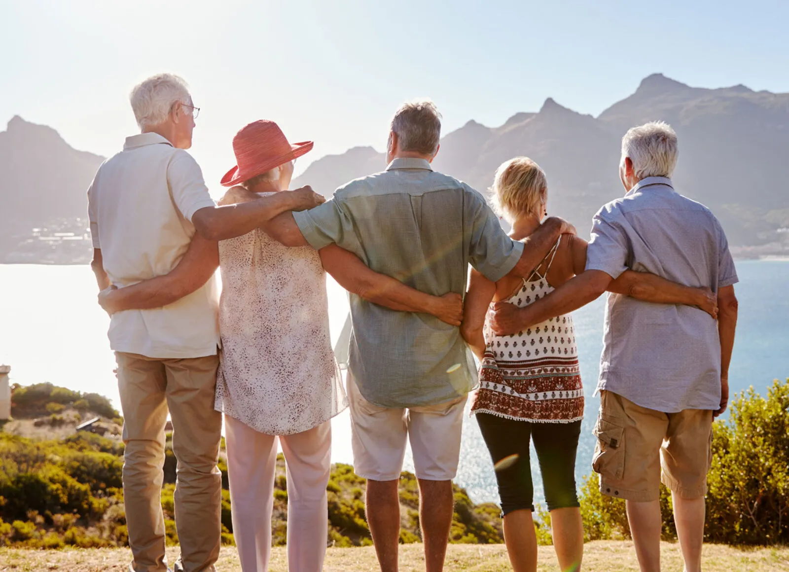older group of tourist enjoying the view of a mountain - Cadillac Travel