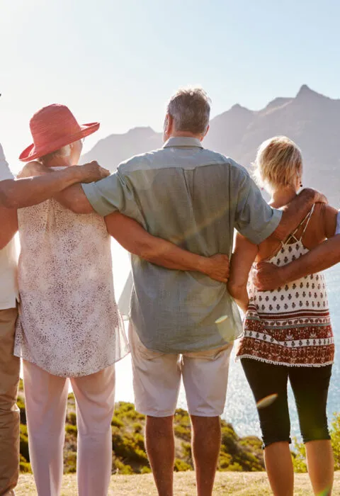 older group of tourist enjoying the view of a mountain - Cadillac Travel
