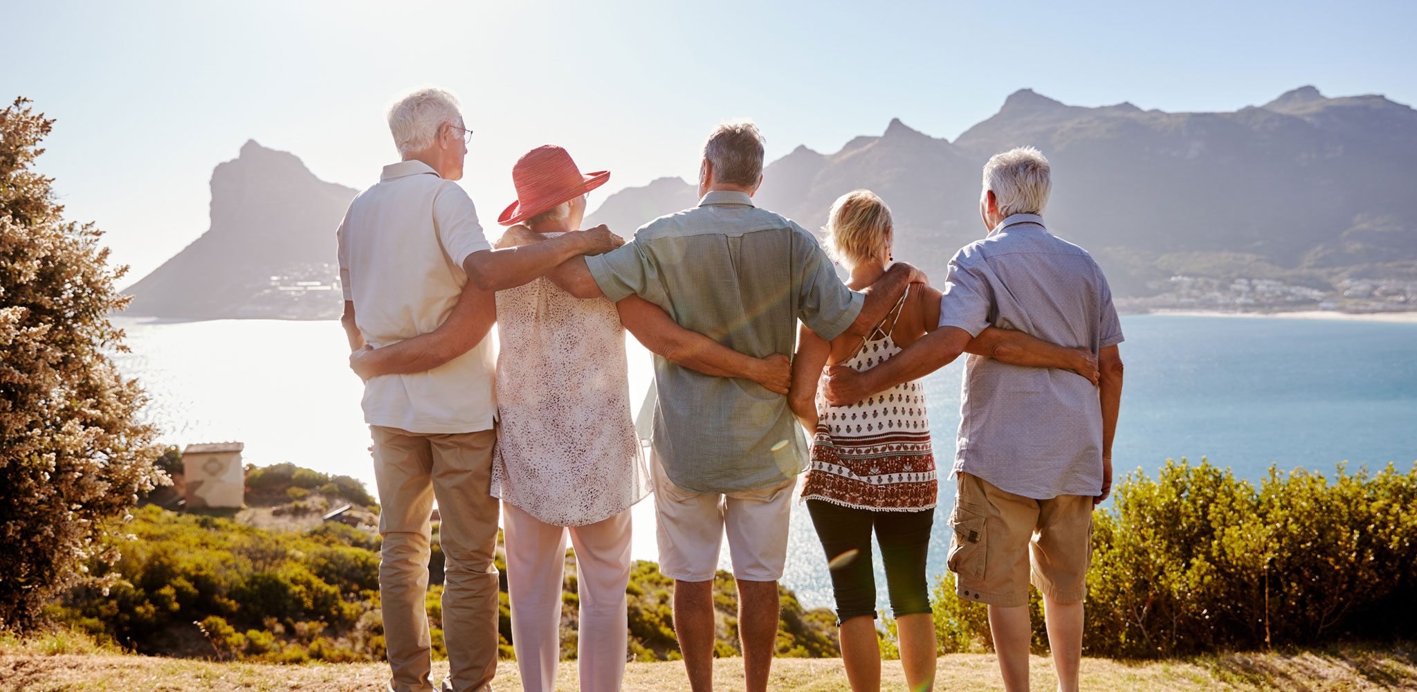 older group of tourist enjoying the view of a mountain - Cadillac Travel