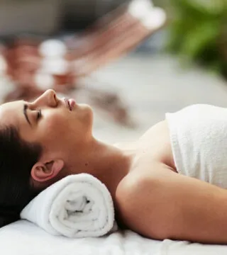 Lady relaxing on a sunbed - Cadillac Travel