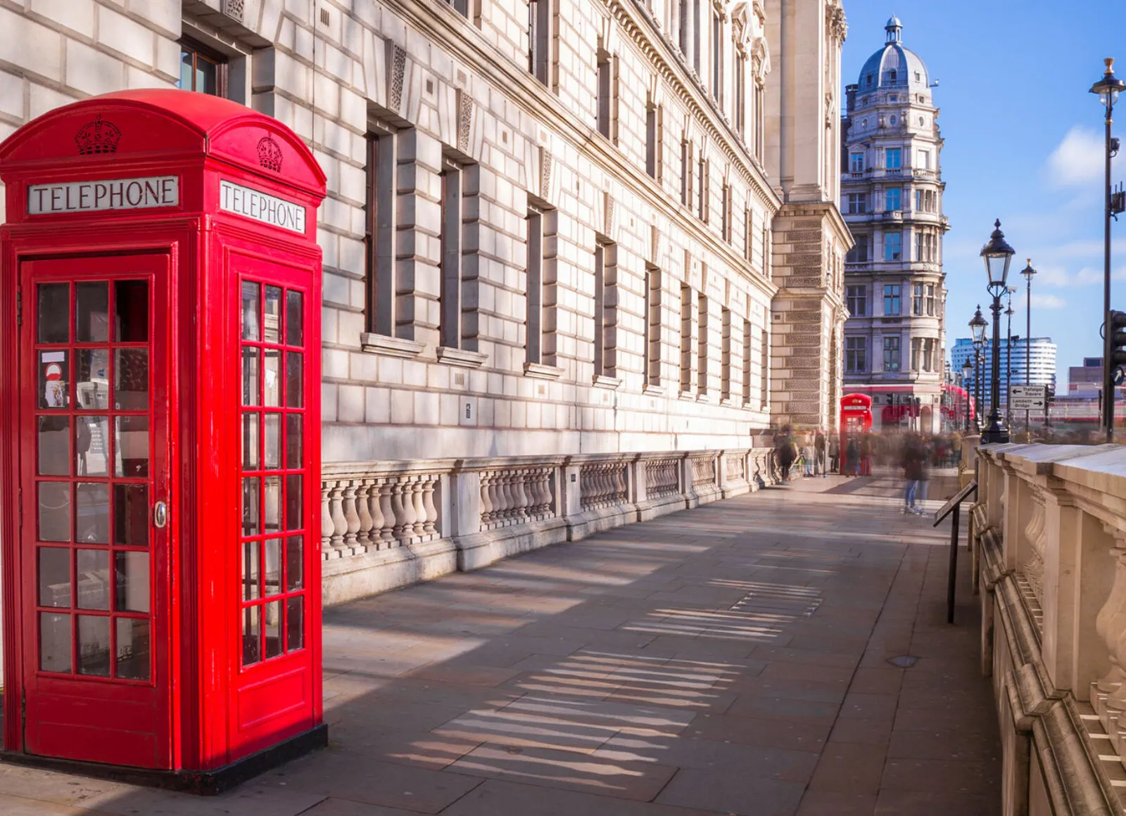 Red phone box in London with Big Ben in the background - Cadillac Travel