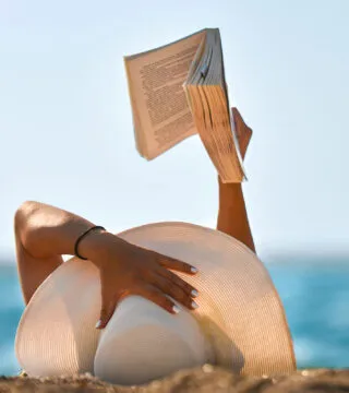 reading on beach - Cadillac Travel