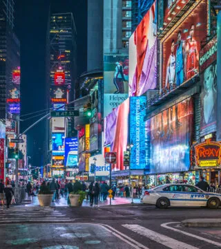 times square, New York at with lights on - Cadillac Travel