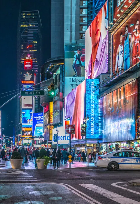 times square, New York at with lights on - Cadillac Travel