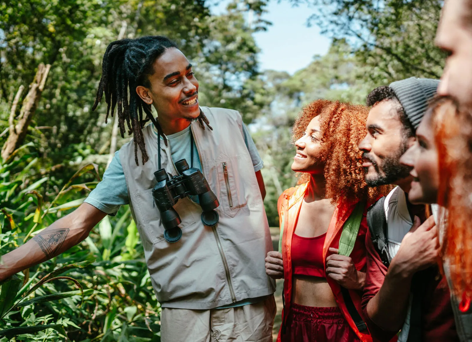 Tour guide showing tourist native vegetation - Cadillac Travel