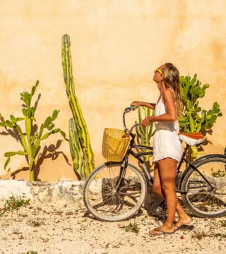woman on a bike admiring the plants - Cadillac Travel