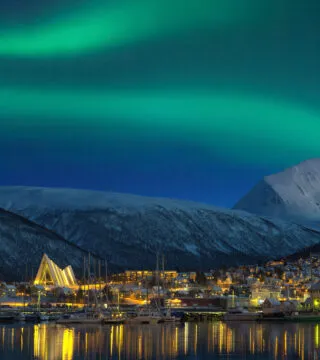 Aurora over snow mountains in the background - Cadillac Travel, Detroit, MI