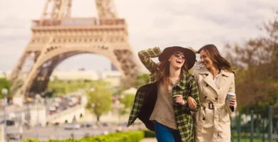 two women sightseeing around the Eiffel Tower, Paris - Cadillac Travel, Detroit, MI