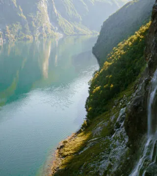 River cruise with ship sailing down river with waterfall - Cadillac Travel, Detroit, MI