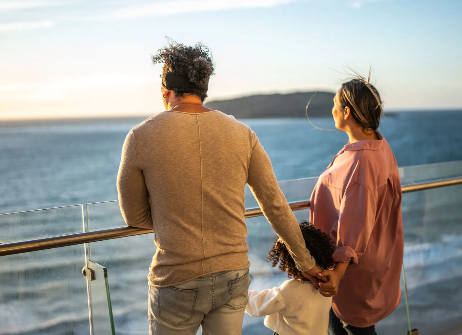 Family holding hands on cruise ship - Cadillac Travel
