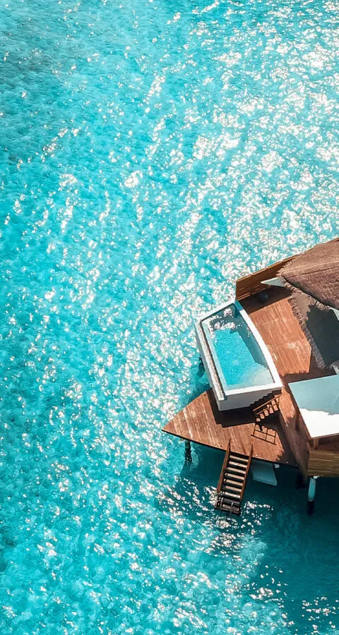 water hut in blue ocean - Cadillac Travel, Detroit, MI